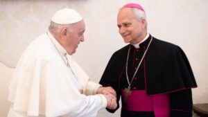 Cardinal Prevost shakes hands with the Pope