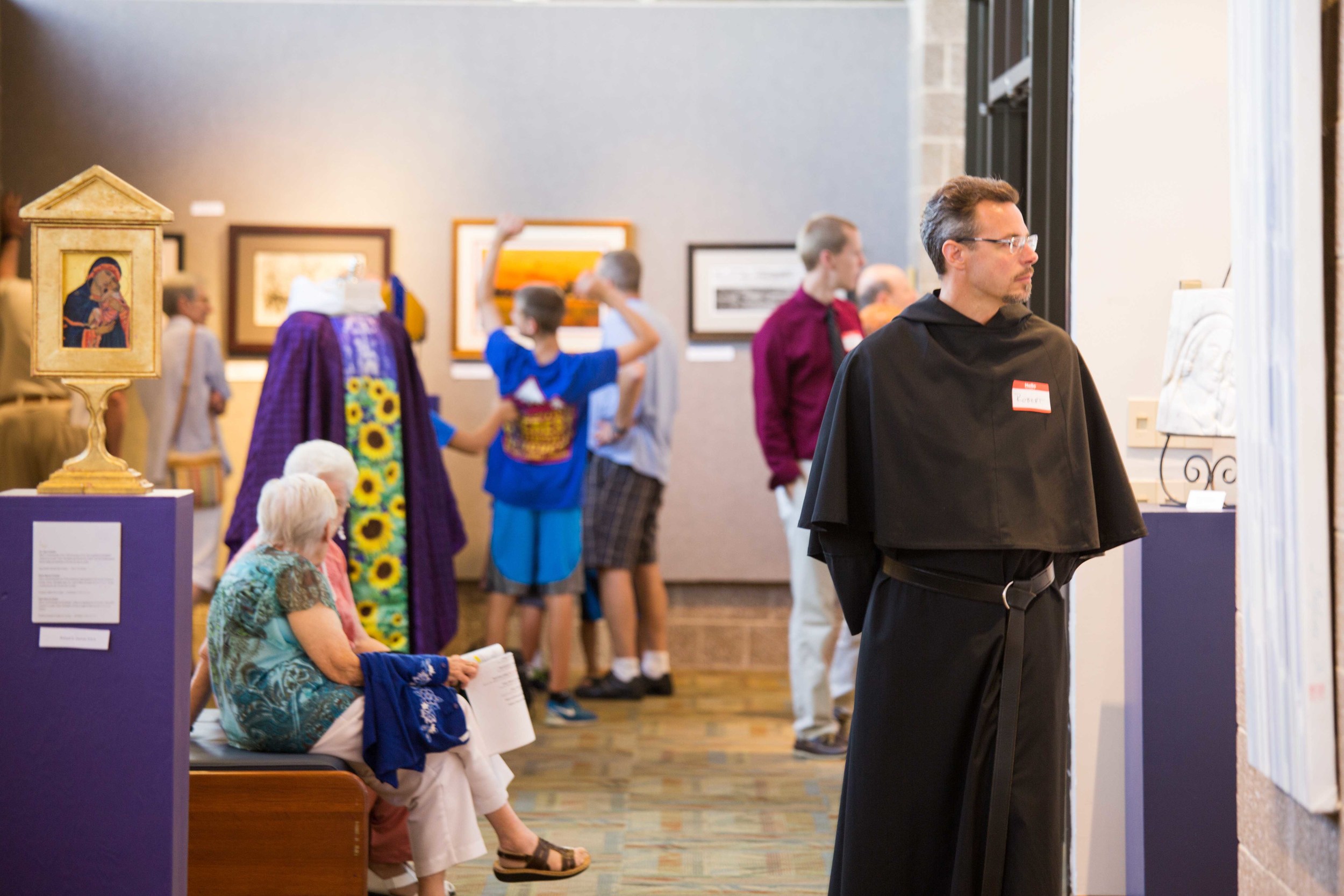 Visitors to the Art Gallery during the "A Day Celebrating Consecrated Life." At the left is an icon of the Madonna and a vestment, both done by Richard Canulli, O.S.A.