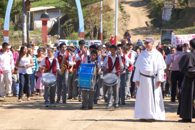 Marching band of Peruvian children with an Augustinian friar marching in a parade