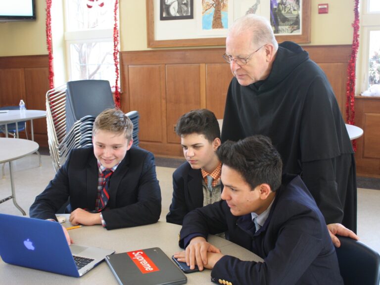 Fr. Donald Reilly, O.S.A., Head of School of Malvern Preparatory School with students of Malvern community