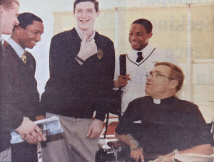 Father Bill Atkinson, O.S.A. with students of Bonner High School